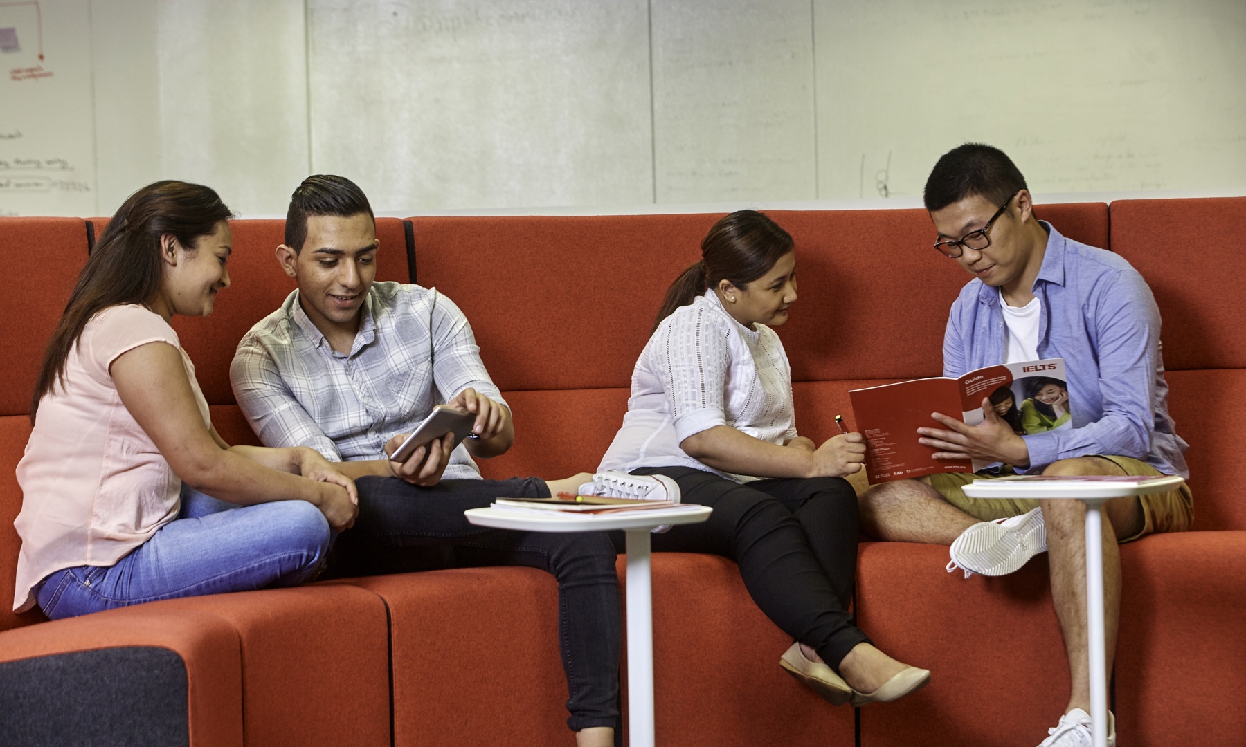Four people discussing IELTS 