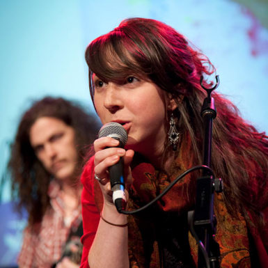 Woman speaking into a microphone