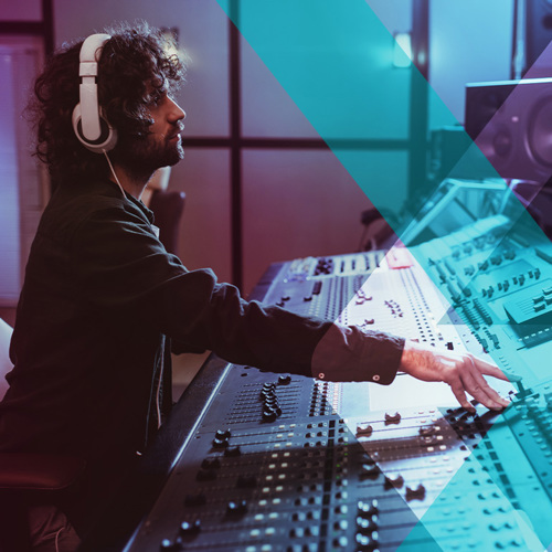 Man sitting at audio mixing desk
