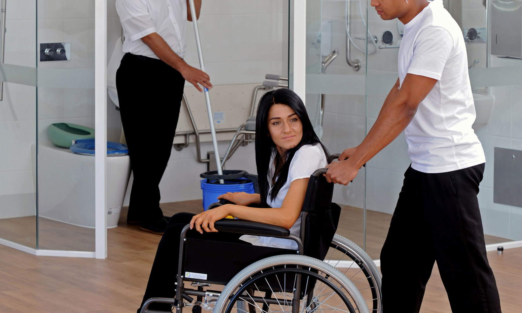 Image of care workers caring for a woman