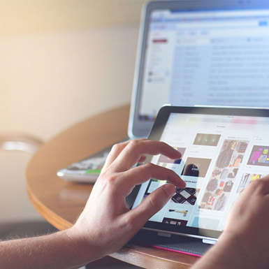 Someone's fingers searching on their iPad looking up online content
