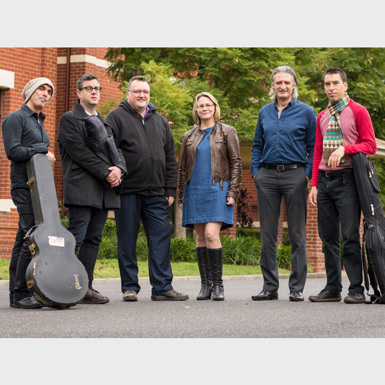 Group of musicians standing with their instruments